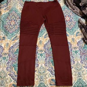 These are maroon leggings with detailing.